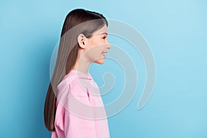Profile side photo of young preteen girl happy positive smile look empty space isolated over blue color background