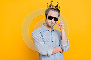 Profile side photo of young serious man hand touch glasses royalty prince isolated over yellow color background