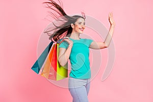 Profile side photo of young woman happy positive smile waving hand hello shopping buy isolated over pastel color