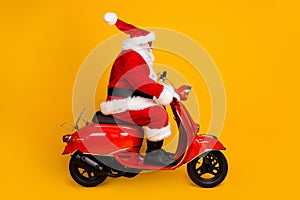 Profile side view of his he nice funny fat thick white-haired Santa riding motor bike fast speed hurry up rush shopping