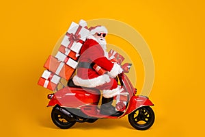 Profile side view of his he nice funny fat white-haired Santa riding moped fast speed hurry up rush carrying bringing