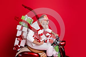 Profile side view of his he nice funny funky gray-haired bearded man riding moto delivering stack desirable purchase air