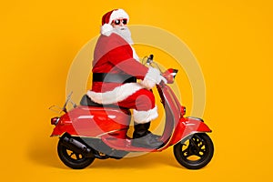 Profile side view of his he nice funny hipster white-haired Santa riding motor bike way road destination travel trip