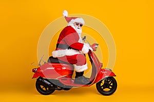 Profile side view of his he nice funny thick white-haired Santa riding motor bike fast speed hurry up rush sale hat ball