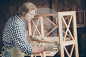 Profile side view of his he nice handsome blond focused serious skilled professional guy woodworker wearing checked