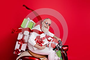 Profile side view of nice attractive funny funky cheerful gray-haired man riding motor delivering pile stack new