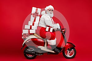 Profile side view of nice bearded cheerful fat funky Santa riding moped carrying pile stack fairy purchases shopping