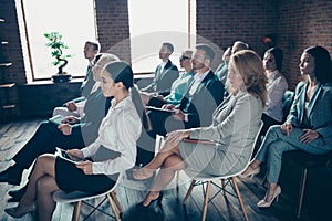 Profile side view of nice serious elegant professional intelligent specialists experts educative classes sitting photo