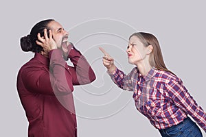 Profile side view portrait of angry woman standing and blaming a