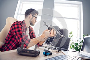 Profile side view portrait of attractive clever focused guy fixing drone bug software detail programming code at work