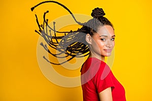 Profile side view portrait of attractive girl wind blowing hair modern coiffure look isolated on bright yellow color