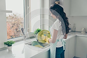 Profile side view portrait of her she nice charming lovely attractive beautiful cheerful wavy-haired house-wife washing