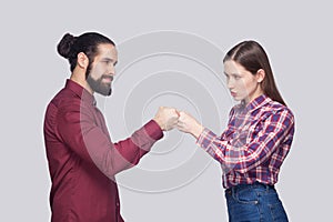 Profile side view portrait of serious bearded man and woman in c