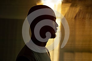 Profile silhouette bald beard Japanese man portrait with sunlight window