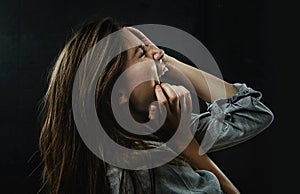 Profile, stress and horror with woman shouting in studio on black background for reaction to fear. Phobia, anxiety and