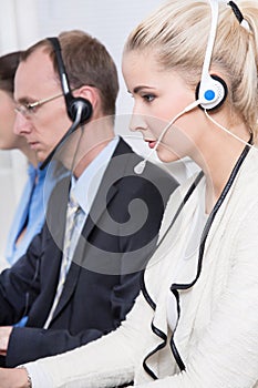 Profile of telesales or helpdesk team concentrating with headset photo