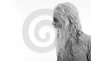 Profile view of angry senior bearded man looking furious while shouting