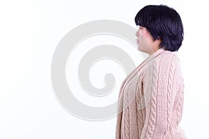 Profile view of beautiful overweight Asian woman ready for winter