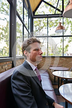 Profile view of businessman thinking at the cafe