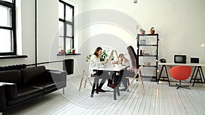 Profile view of a couple of adults working on a painting at an art school 4k 20s