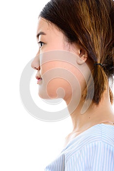 Profile view of face of young beautiful Asian woman