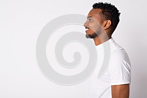 Profile view of happy young handsome African man smiling