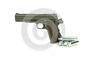 Profile view of isolated semi-automatic airsoft handgun with gas container. Replica of real handgun on white background.