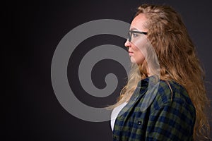 Profile view portrait of young beautiful woman with long wavy blond hair