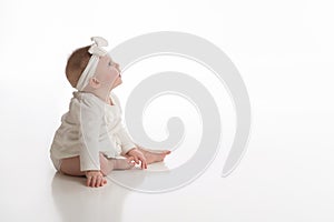 Profile View of a Smiling Baby Girl Wearing White