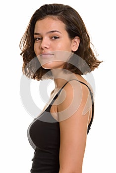 Profile view of teenage girl looking at camera