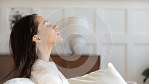 Profile view of woman relax on couch with eyes closed