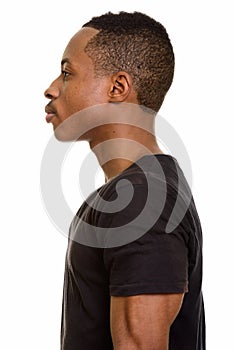 Profile view of young African man isolated against white background