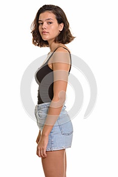 Profile view of young beautiful Caucasian teenage girl looking at camera