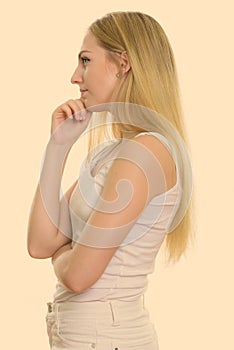 Profile view of young beautiful teenage girl thinking