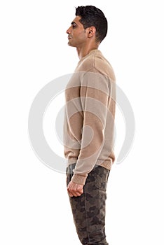 Profile view of young muscular Persian man standing