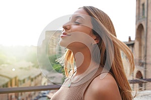 Profile of woman breathe relaxed with closed eyes on sunset. Beauty sunshine girl side portrait. Positive emotion life success