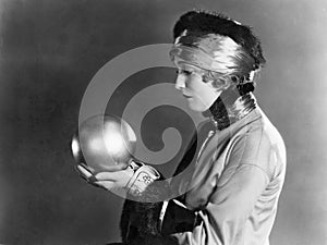 Profile of a woman holding a metal ball