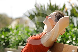 Profile of a woman resting sitting on bench in a park