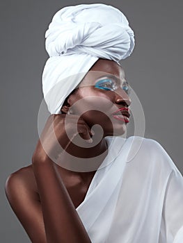 Profile, wrap and black woman with makeup, fashion and confidence in studio on grey background. Face, beauty or proud