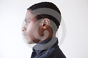 Profile young african man against white background