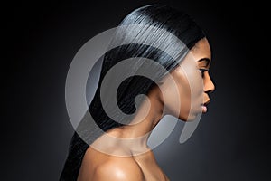 Profile of an young black beauty with long straight hair