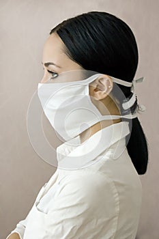 The profile of young girl in a medical mask