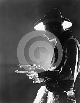 Profile of a young man holding guns