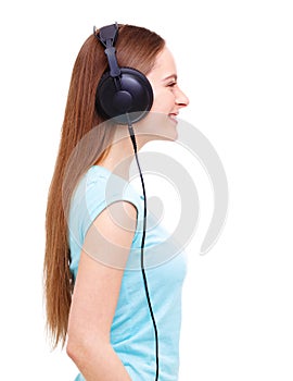 Profile of young woman with headphones listening to music - isolated on white