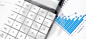 Profit bar chart, pen and calculator. Shallow DOF Focus on the pen