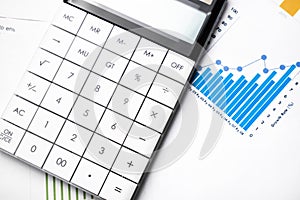 Profit bar chart, pen and calculator. Shallow DOF Focus on the pen