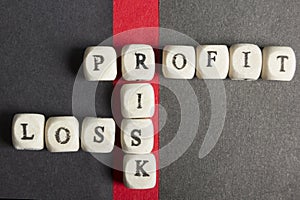 Profit, loss and risk crossword blocks on table. Top view