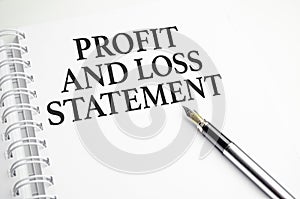 profit and loss statement words on white notebook