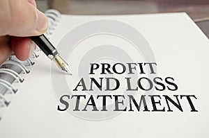 profit and loss statement words on white notebook