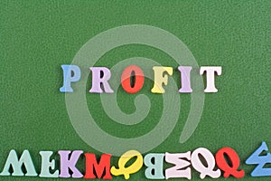 PROFIT word on green background composed from colorful abc alphabet block wooden letters, copy space for ad text. Learning english